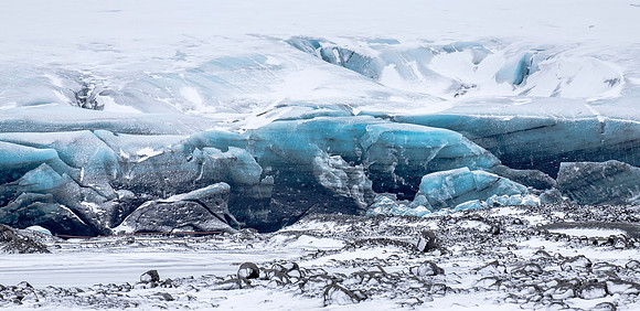 The glacier's toe meets stony ground.