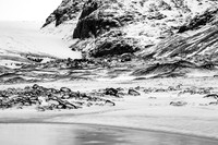 Black rocks at the foot of the glacier.